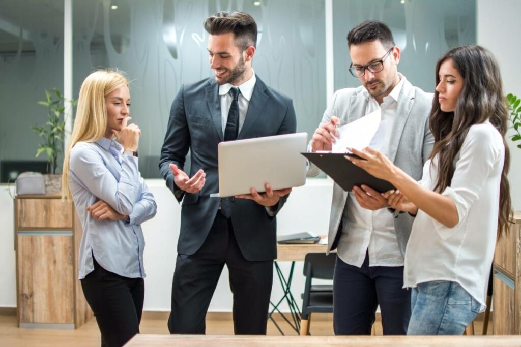 Boss Talking To His Employees About Their Projects